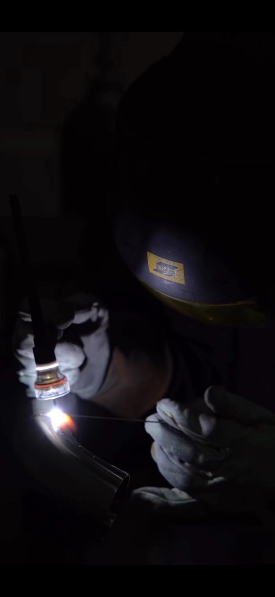 A fabricator welding an exhaust